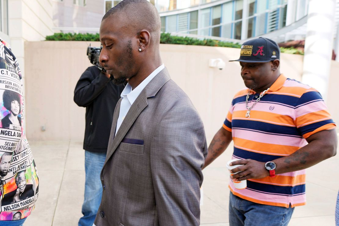 Victims Michael Corey Jenkins, left, and Eddie Terrell Parker enter the Thad Cochran US Courthouse in Jackson, Mississippi, to attend a Wednesday sentencing hearing for an ex-deputy who tortured them.