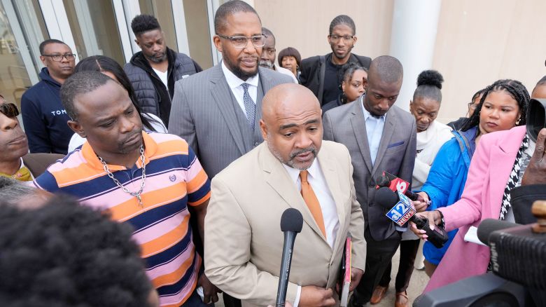 Civil co-counsel Trent Walker, center, speaks to reporters on the sentencing of the third former Rankin County law enforcement officer, while his clients, Eddie Terrell Parker, left, Michael Corey Jenkins, listen while outside the federal courthouse in Jackson, Miss., Wednesday, March 20, 2024. Former Rankin County deputy Daniel Opdyke was sentenced to 17.5 years in federal prison for his role with five other now former Rankin County law enforcement officers, in the racially motivated, violent torture of Parker and Jenkins. (AP Photo/Rogelio V. Solis)