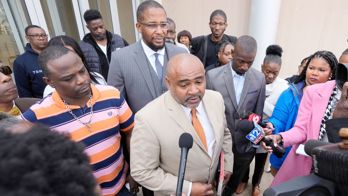 Attorney Trent Walker, center, speaks to reporters March 20 as his clients Eddie Parker, left, and Michael Jenkins, right, listen outside the federal courthouse in Jackson, Mississippi.