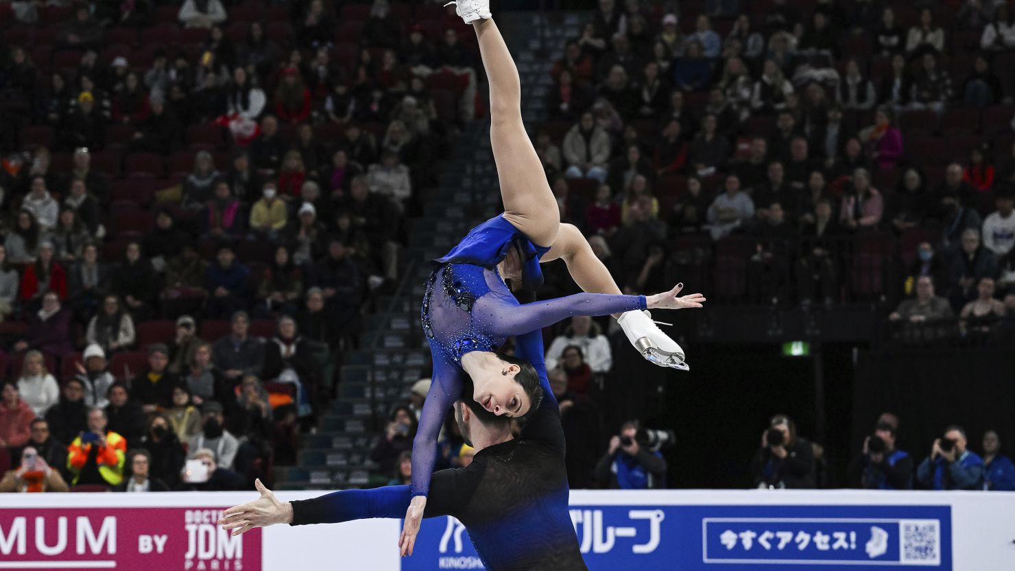 Deanna Stellato-Dudek and Maxime Deschamps perform an overhead rotational lift during their short program at the 2024 World Figure Skating Championships.