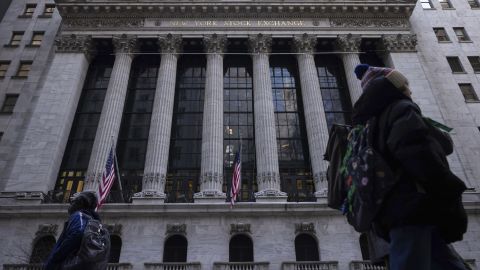 People walk past the New York Stock Exchange Thursday, March 21, 2024.