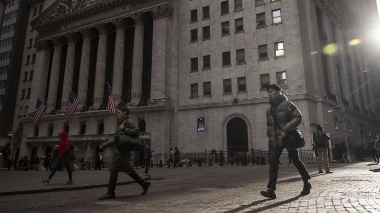People walk past the New York Stock Exchange Thursday, March. 21, 2024.