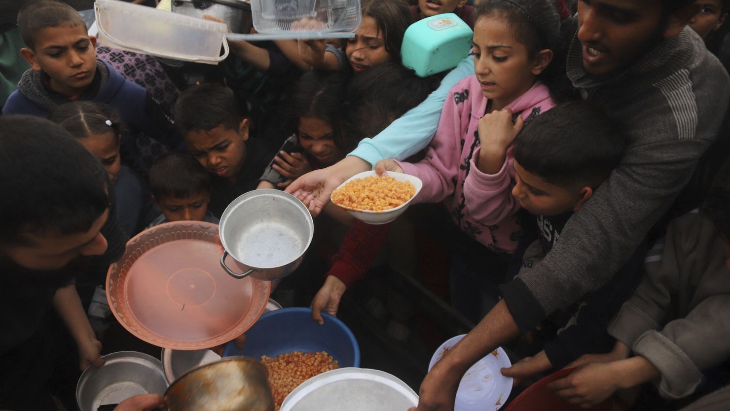People gather to get food relief in the southern Gaza Strip city of Rafah, on March 21.