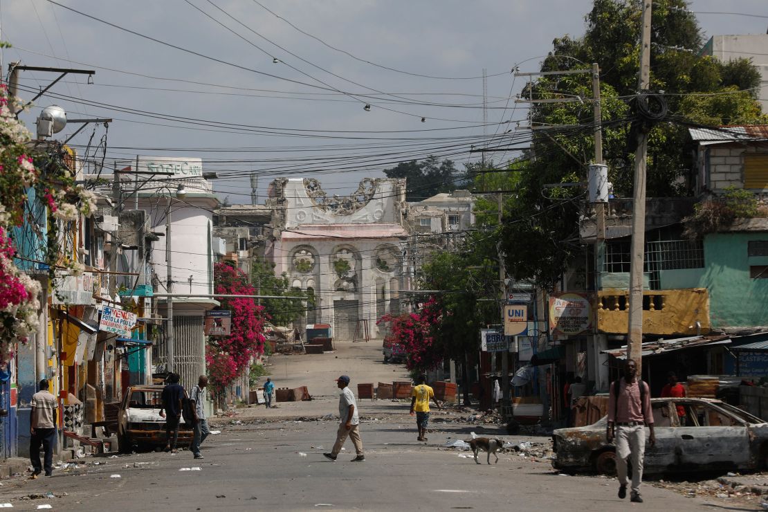 Pedestrians walk on an empty street near the earthquake-destroyed Cathedral in Port-au-Prince, Haiti, Monday, March 25, 2024.