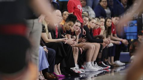 Players and staff from Utah's women's basketball team watch on during the NCAA Tournament.