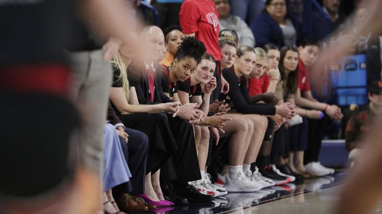 Players and staff from Utah's women's basketball team watch on during the NCAA Tournament.