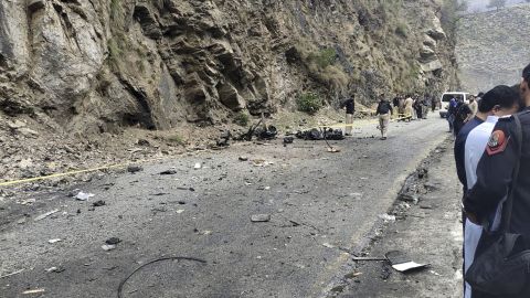 Police officers examine the site of suicide bombing at a highway in Shangla, a district in the Pakistan's Khyber Pakhtunkhwa province, Tuesday, March 26, 2024. A suicide bomber in northwest Pakistan rammed his explosive-laden car into a vehicle Tuesday, killing five Chinese nationals and their Pakistani driver, police and government officials said. (AP Photo)