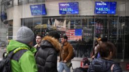 Pedestrians walk past the Nasdaq building Tuesday, March 26, 2024, in New York. Trump Media, which runs the social media platform Truth Social, now takes Digital World's place on the Nasdaq stock exchange.