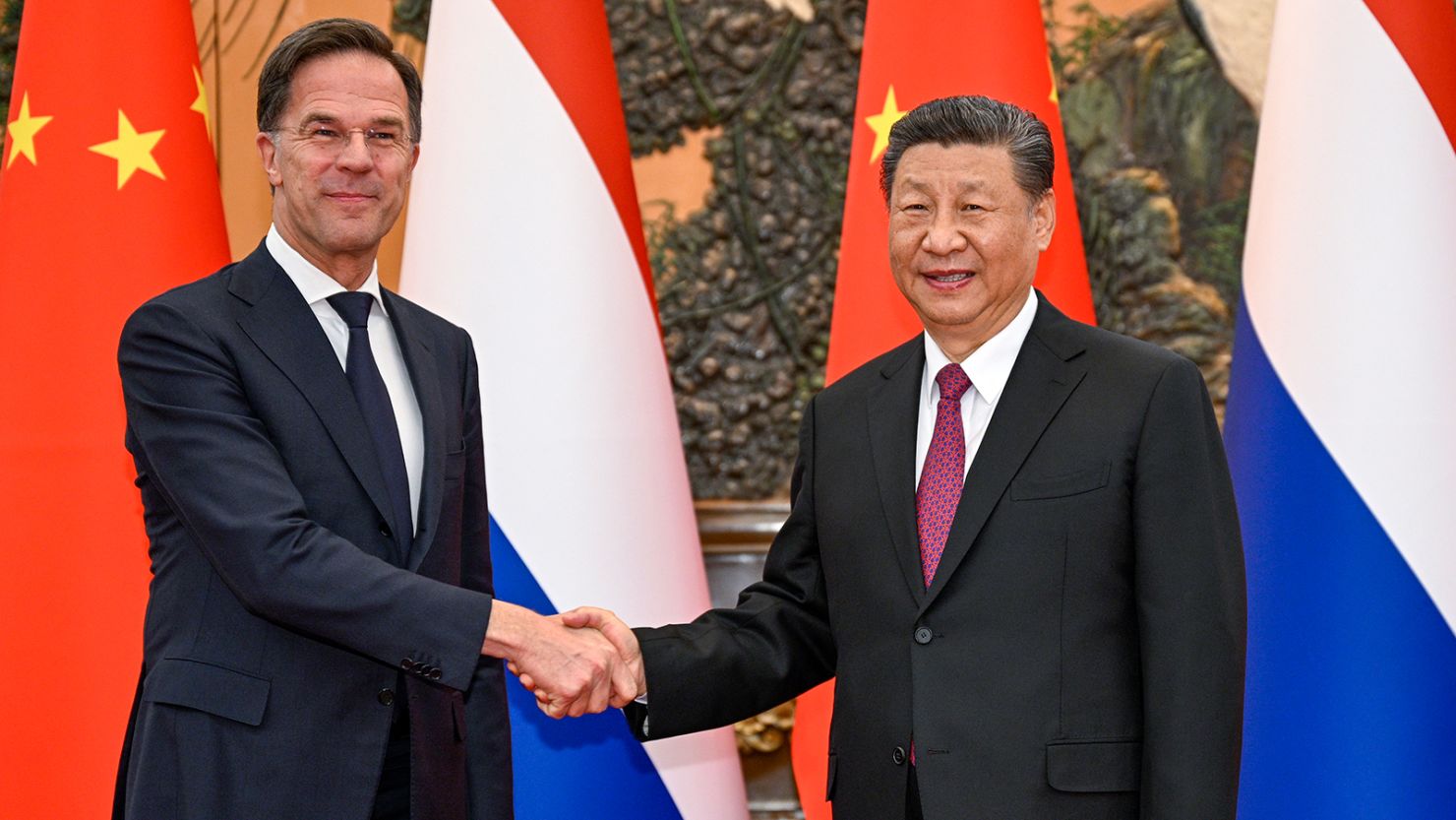 In this photo released by Xinhua News Agency, Chinese President Xi Jinping, right, shakes hands with Dutch Prime Minister Mark Rutte at the Great Hall of the People in Beijing.