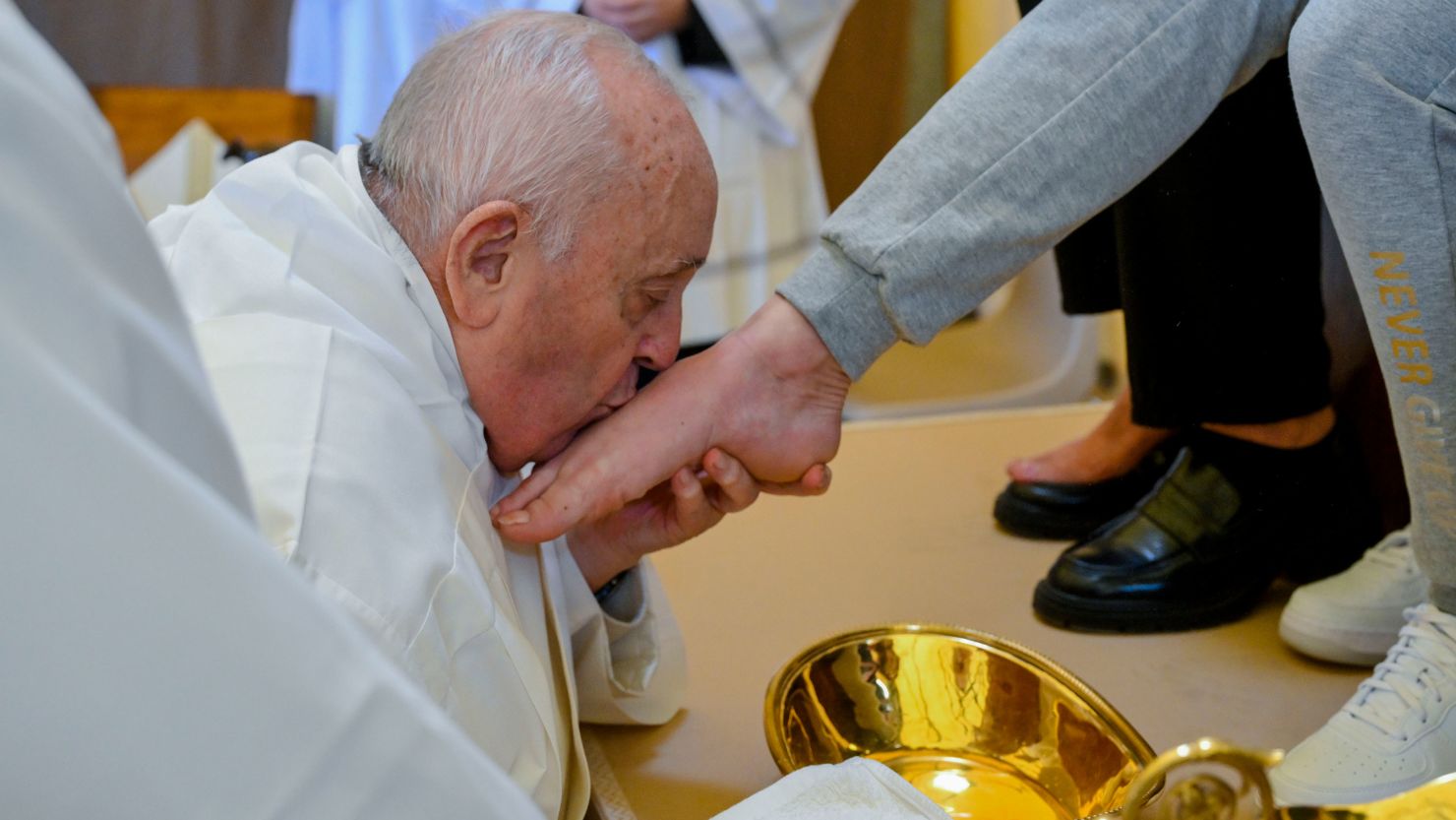 Pope Francis kisses the foot of a woman inmate of the Rebibbia prison on the outskirts of Rome on Holy Thursday, March 28, 2024, a ritual meant to emphasize his vocation of service and humility.