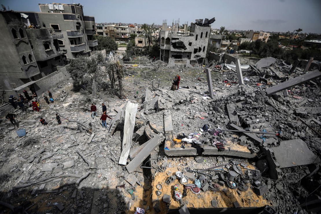 Palestinians inspect the damage to a residential building after an Israeli airstrike in the Maghazi refugee camp, central Gaza Strip, Friday, March 29, 2024. (AP Photo/Ismael Abu Dayyah)
