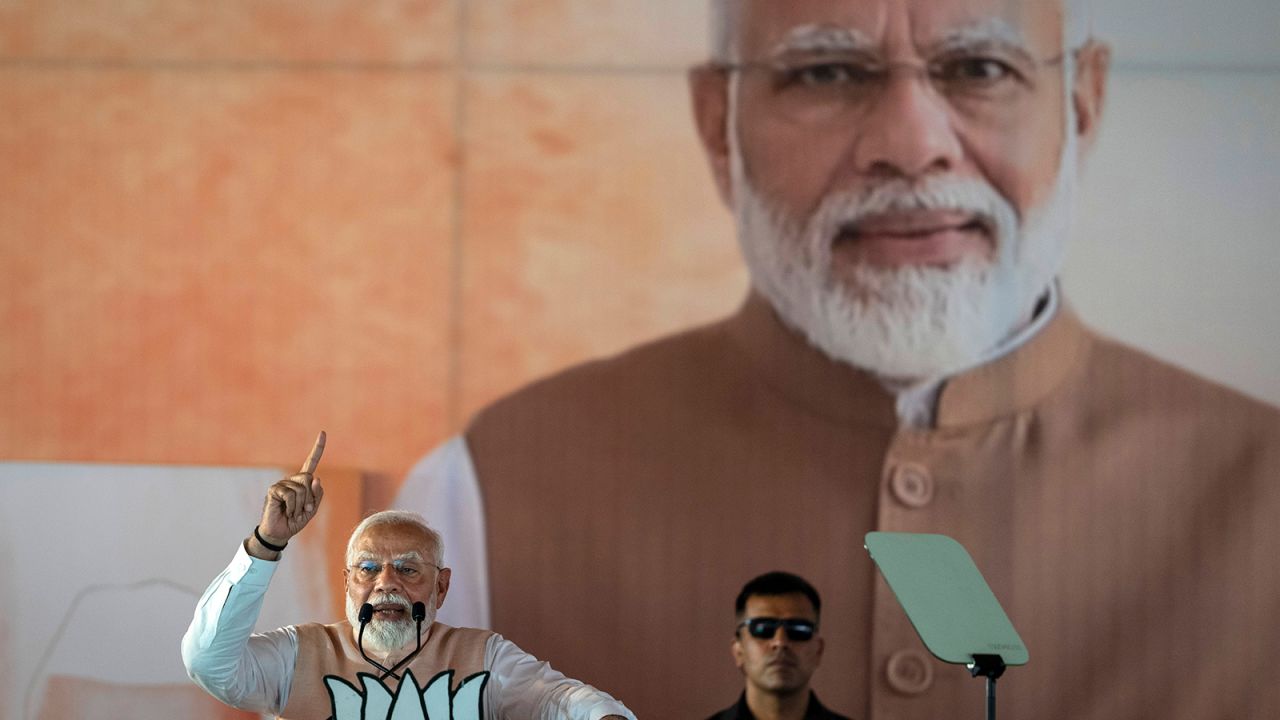 A large portrait of Indian Prime Minister Narendra Modi is displayed behind him as he speaks at an election campaign rally in Meerut, India, Sunday, March 31, 2024.