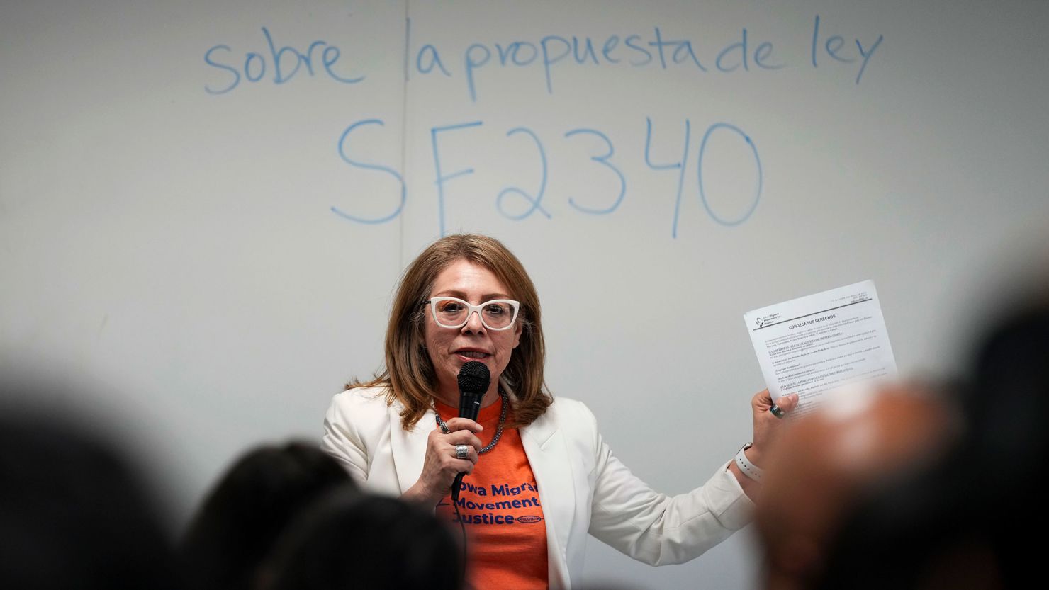 Community organizer Maria Acosta fields questions about an immigration bill that recently passed in Iowa at an informational meeting on March 27. Dozens of concerned people packed into a room at a Des Moines library, searching for answers.