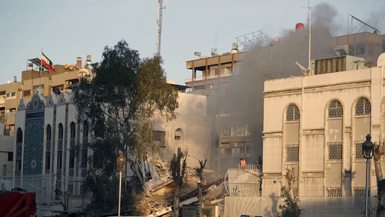 Emergency services work at a destroyed building hit by an air strike in Damascus, Syria, Monday, April 1, 2024. An Israeli airstrike has destroyed the consular section of Iran's embassy in Damascus, killing or wounding everyone inside, Syrian state media said Monday. (AP Photo/Omar Sanadiki)