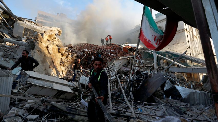 Emergency services work at a destroyed building hit by an air strike in Damascus, Syria, Monday, April 1, 2024. An Israeli airstrike has destroyed the consular section of Iran's embassy in Damascus, killing or wounding everyone inside, Syrian state media said Monday. (AP Photo/Omar Sanadiki)