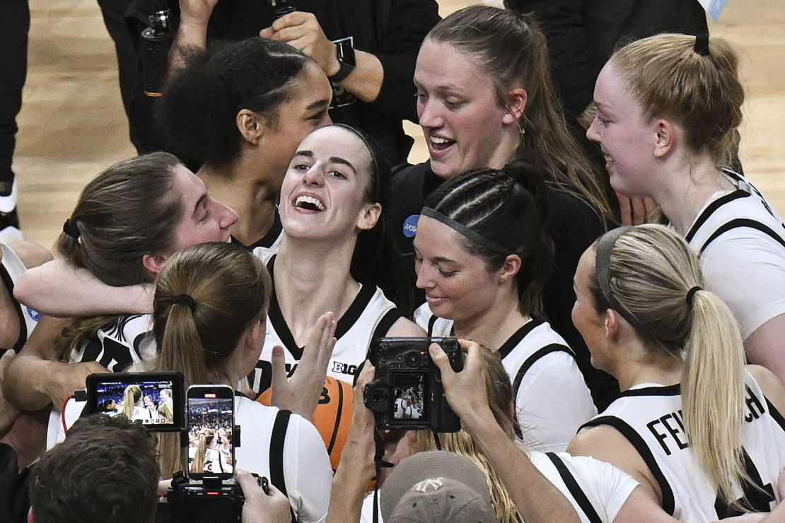 Clark celebrates with her teammates after Iowa defeated LSU in the Elite Eight.