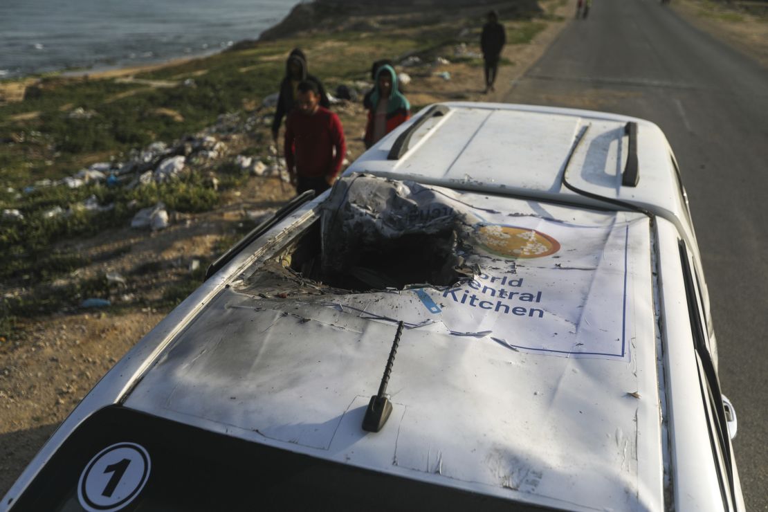 Palestinians inspect a vehicle with the logo of the World Central Kitchen wrecked by an Israeli airstrike in Deir al Balah, Gaza Strip, on April 2.
