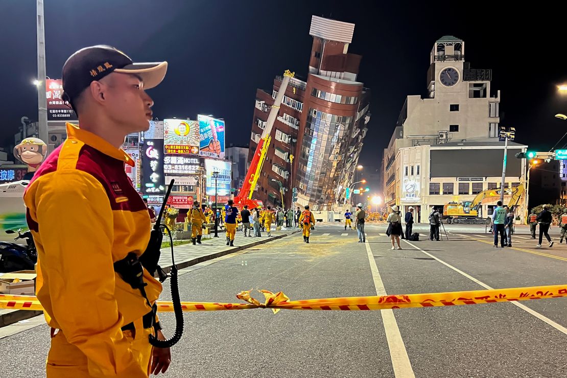 A rescue worker stands near the cordoned off site in the aftermath of an earthquake in Hualien, eastern Taiwan on Wednesday, April 3, 2024.