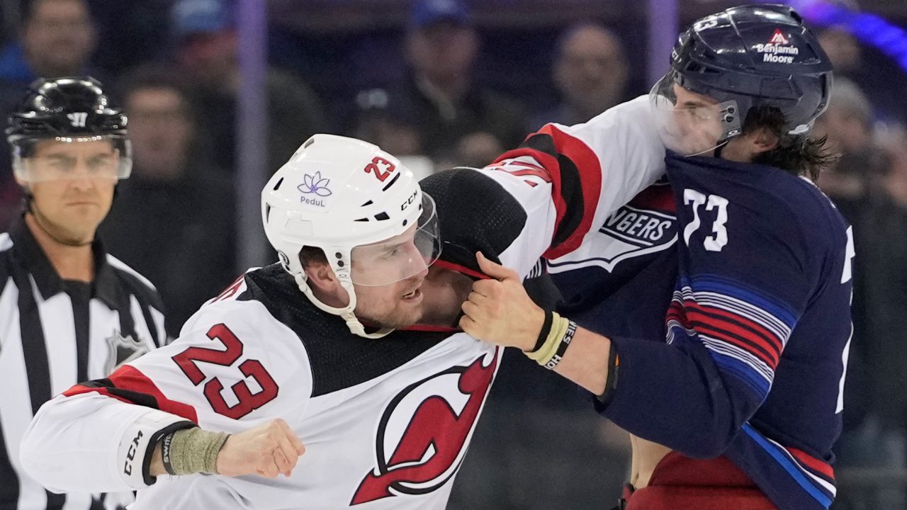 New Jersey Devils defenseman Kurtis MacDermid (23) fights New York Rangers center Matt Rempe (73) during the first period of an NHL hockey game, Wednesday, April 3, 2024, at Madison Square Garden in New York.
