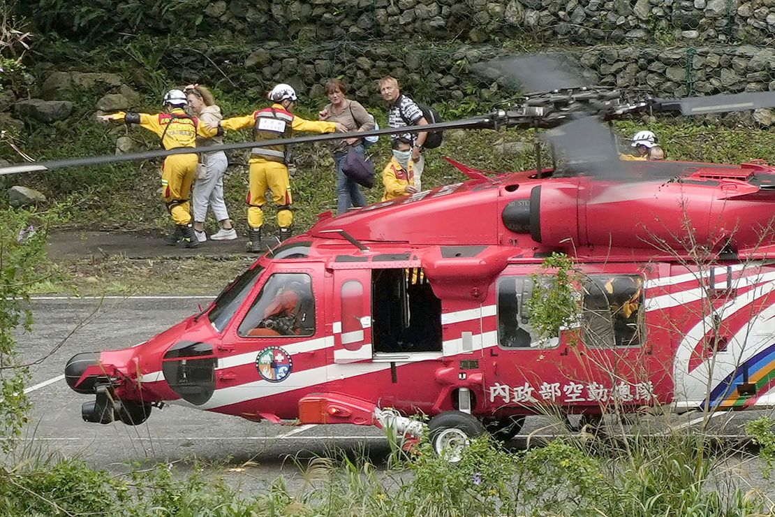 People leave a helicopter after being rescued from an isolated area following a powerful earthquake in Hualien City, Taiwan, Saturday, April 6, 2024