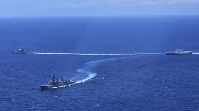 In this photo provided by the Armed Forces of the Philippines, from left, Australian Navy ship HMAS Warramunga, Japan Maritime Self-Defense Forces ship JS Akebono and United States Navy ship USS Mobile (LCD-26) maneuver during the first Multilateral Maritime Cooperative Activity at the disputed South China Sea on Sunday, April 7, 2024. The United States, Japan, Australia and the Philippines held their first joint naval exercises, including anti-submarine warfare training, in a show of force Sunday in the South China Sea where Beijing's aggressive actions to assert its territorial claims have caused alarm. (Armed Forces of the Philippines via AP)