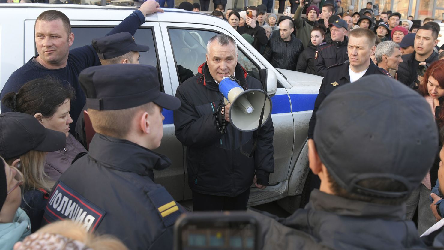 Orsk Mayor Vasily Kozupitsa, centre, speaks to the residents during a protest over local authorities' perceived inaction after a dam broke in the city.