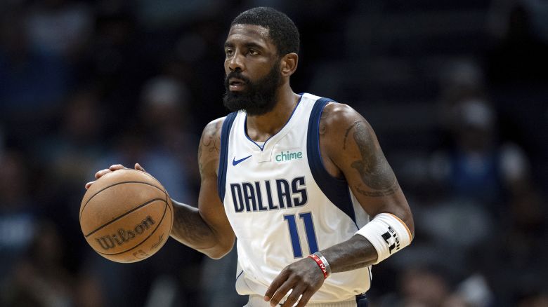 Dallas Mavericks guard Kyrie Irving (11) brings the ball upcourt against the Charlotte Hornets during the second half of an NBA basketball game Tuesday, April 9, 2024, in Charlotte, N.C. (AP Photo/Jacob Kupferman)