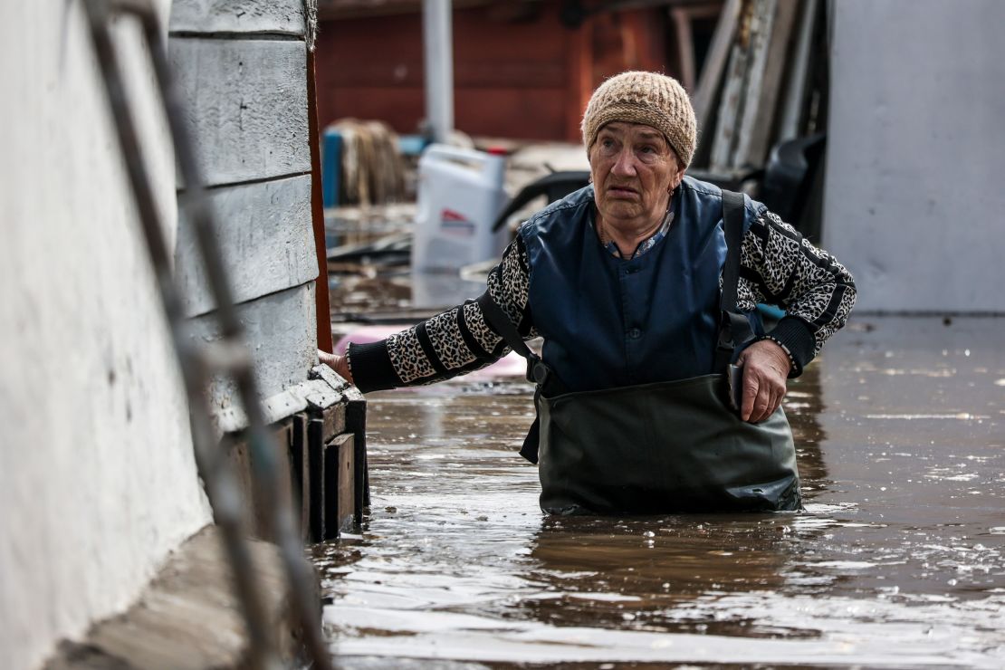 A woman walks near her flooded house in Orenburg on Wednesday.