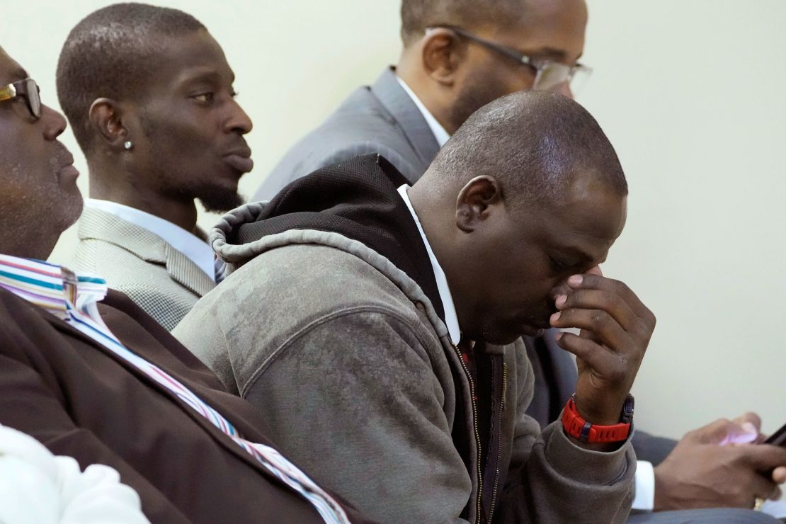 Eddie Terrell Parker, right, and his friend Michael Corey Jenkins react during Wednesday's sentencing hearing for six former Mississippi law enforcement officers who abused them for hours.