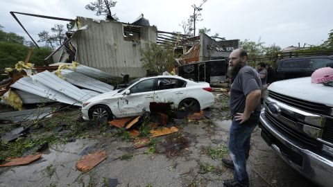 People survey a severely damaged business Slidell, Louisiana, after severe storms swept through on  April 10, 2024.