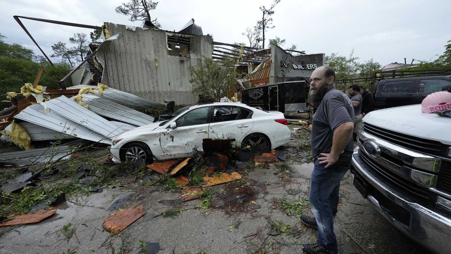 People survey a severely damaged business Slidell, Louisiana, after severe storms swept through on Wednesday.