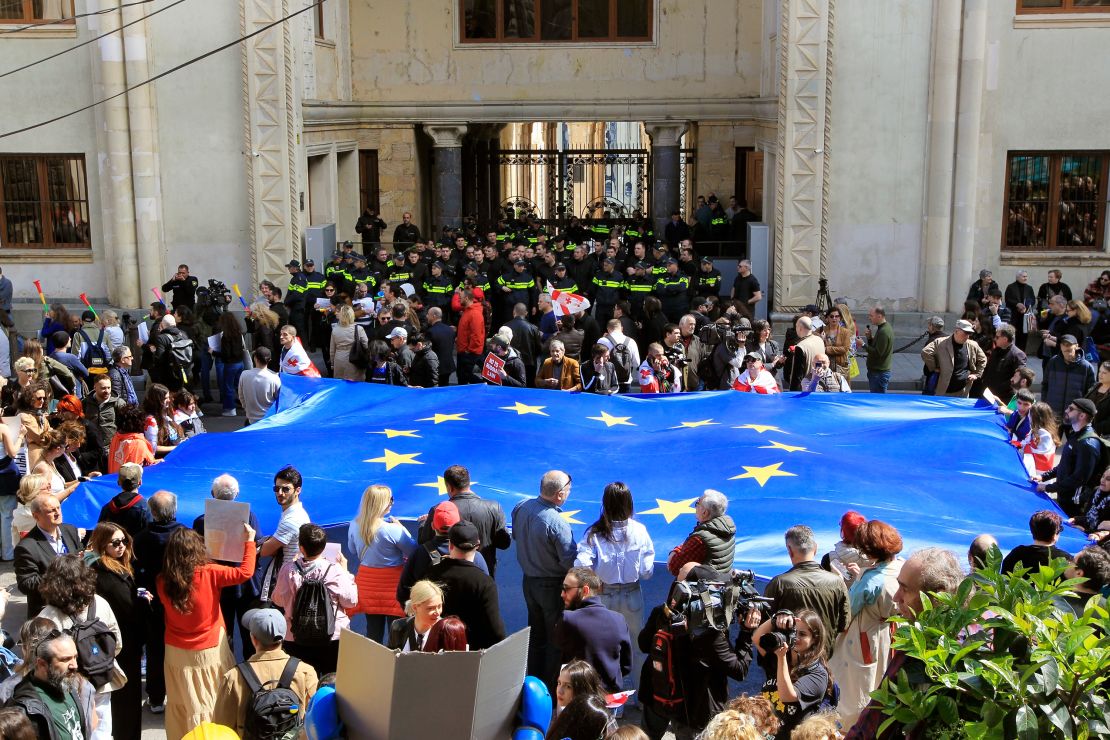 Protesters hold a giant EU flag outside Georgia's Parliament on Monday.