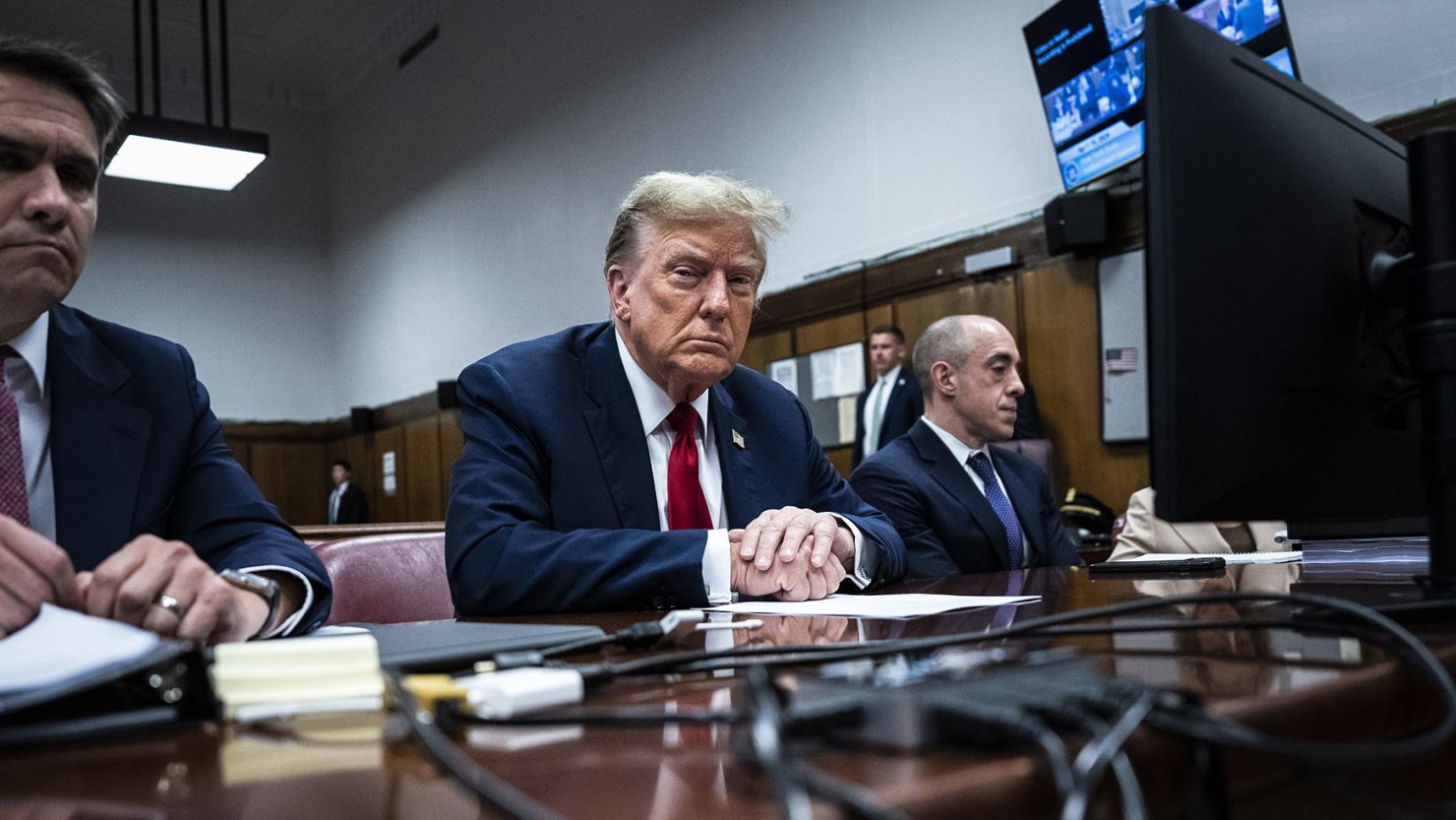 Former President Donald Trump sits in Manhattan criminal court with his legal team ahead of the start of jury selection in New York, Monday, April 15, 2024.