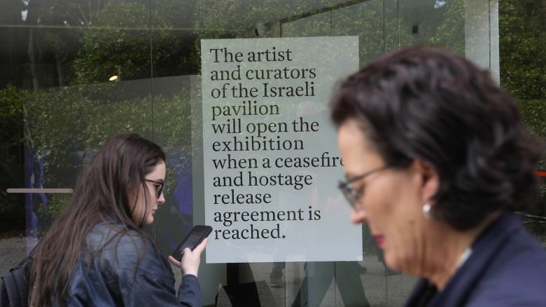 People stand in front of the closed Israeli national pavilion at the Biennale contemporary art fair in Venice, Italy, Tuesday, April 16, 2024.
