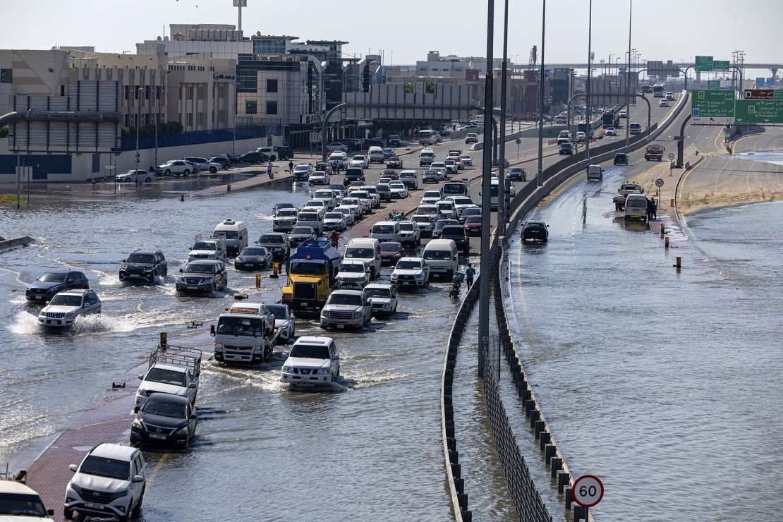 Vehicles drive through floodwater caused by heavy rain in Dubai on Thursday.