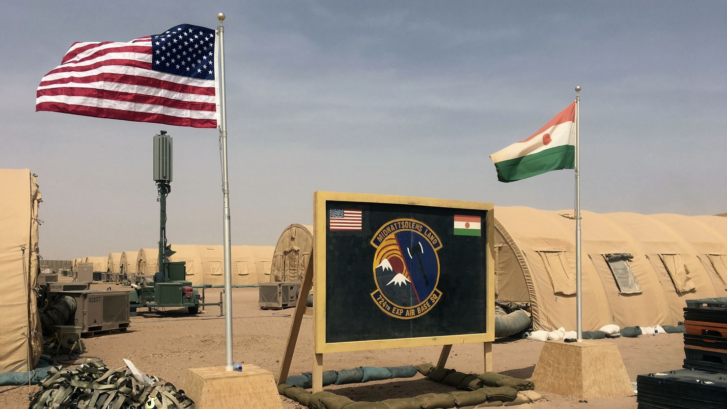 The flags of the United States and of Niger are raised side by side at the base camp for air forces and other personnel supporting the construction of Niger Air Base 201 in Agadez on April 16, 2018.