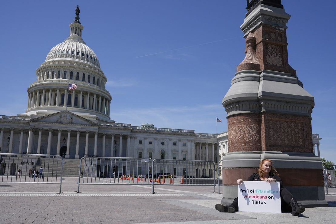 Jennifer Gay, a TikTok content creator, sits outside the U.S. Capitol, Tuesday, April 23, 2024, in Washington as Senators prepare to consider legislation that would force TikTok's China-based parent company to sell the social media platform under the threat of a ban, a contentious move by U.S. lawmakers.