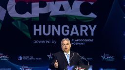Hungarian Prime Minister Viktor Orban speaks at a podium. Behind him is a giant banner reading CPAC Hungary.
