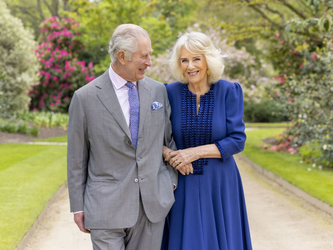 In this handout photo from Buckingham Palace, King Charles III and Queen Camilla stand in Buckingham Palace gardens on April 10.