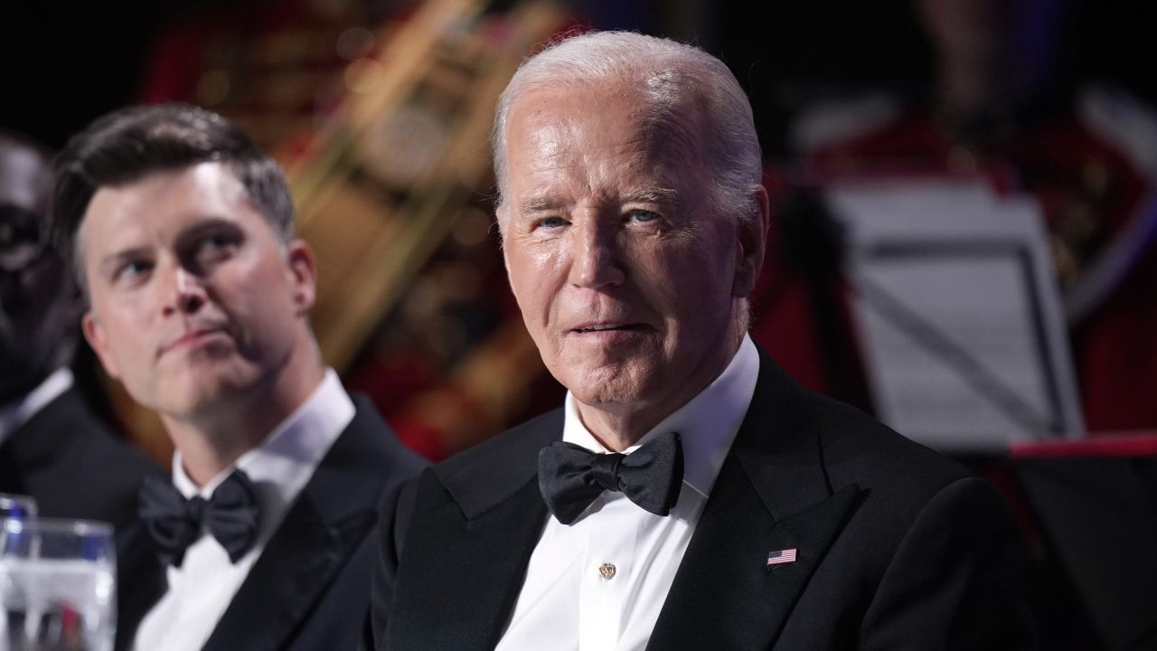 President Joe Biden sits as host Colin Jost, left, looks on at the White House Correspondents' Association Dinner at the Washington Hilton, Saturday, April 27, 2024, in Washington.