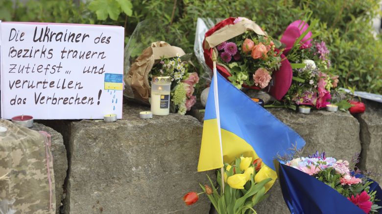 Flowers and a small Ukrainian flag are laid at a shopping center in Murnau, Germany, on April 28, 2024, near to where the men were stabbed.