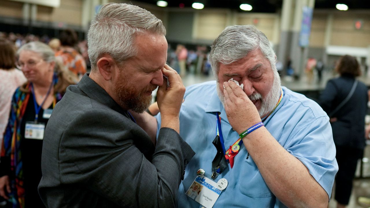 David Oliver, left, and David Meredith wipe away tears after an approval vote at the United Methodist Church General Conference Wednesday, May 1, 2024, in Charlotte, N.C. United Methodist delegates repealed their churchâs longstanding ban on LGBTQ clergy with no debate on Wednesday, removing a rule forbidding âself-avowed practicing homosexualsâ from being ordained or appointed as ministers. (AP Photo/Chris Carlson)