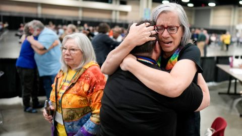 Angie Cox, left, and Joelle Henneman hug after an approval vote at the United Methodist Church General Conference Wednesday, May 1, 2024, in Charlotte, N.C. United Methodist delegates repealed their churchâs longstanding ban on LGBTQ clergy with no debate on Wednesday, removing a rule forbidding âself-avowed practicing homosexualsâ from being ordained or appointed as ministers.(AP Photo/Chris Carlson)