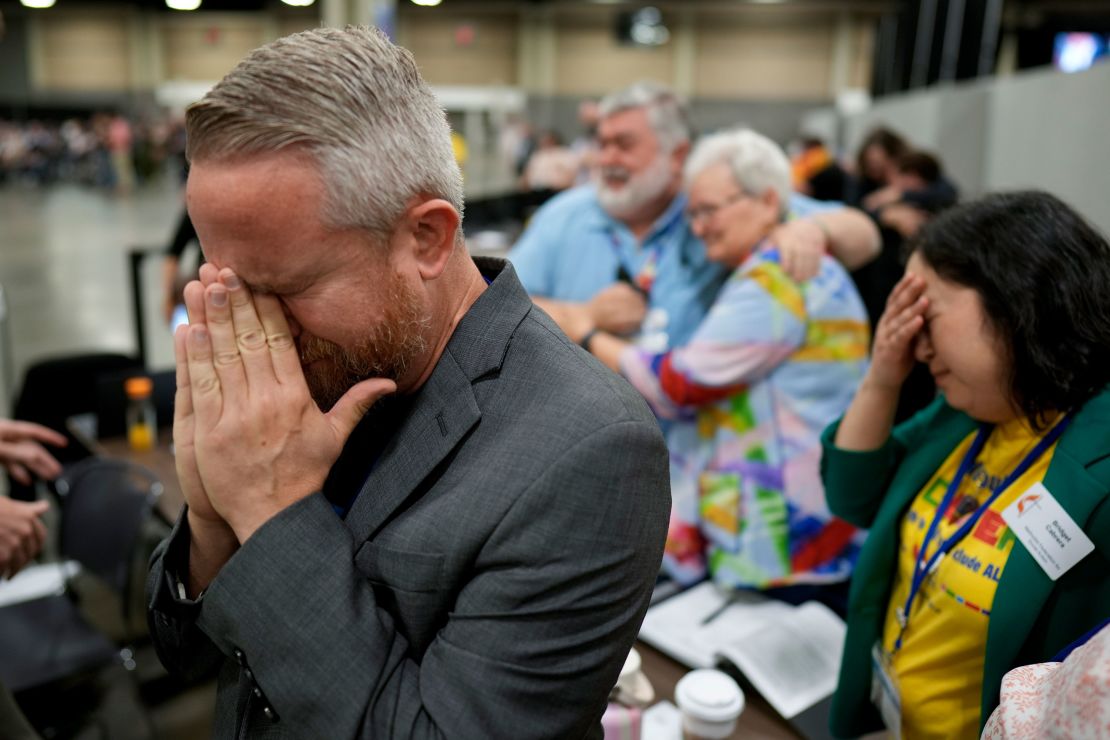 Rev. Andy Oliver reacts after the United Methodist Church removes a rule forbidding "self-avowed practicing homosexuals" from being ordained or appointed as ministers.