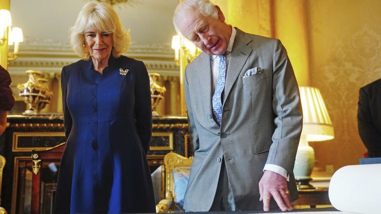 King Charles III and Queen Camilla are presented with the Coronation Roll, an official record of their Coronation, at Buckingham Palace on Wednesday. 