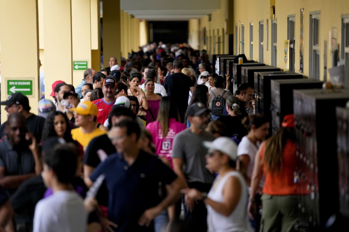 Voters walk inside a polling station during a general election in Panama City, Sunday, May 5, 2024