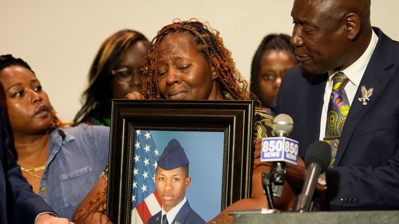 Chantimekki Fortson, mother of Roger Fortson, a U.S. Navy airman, holds a photo of her son during a news conference regarding his death, with Attorney Ben Crump, right, Thursday, May 9, 2024, in Ft. Walton Beach, Fla. Fortson was shot and killed by police in his apartment on May 3, 2024. (AP Photo/Gerald Herbert)