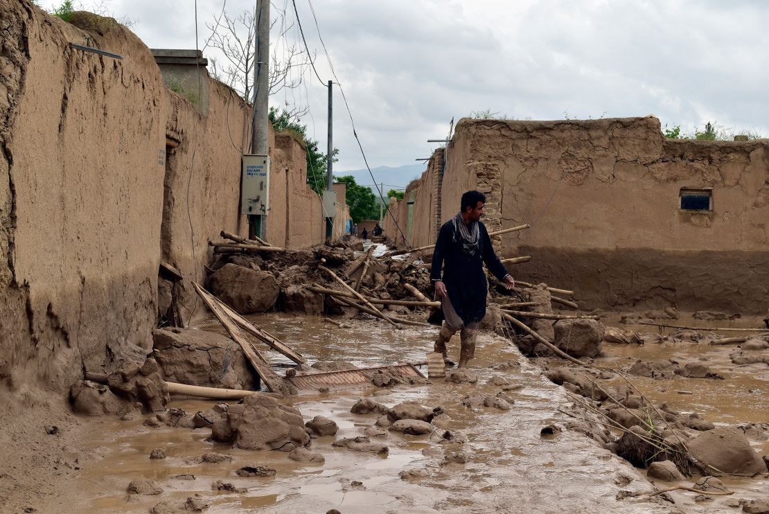 An Afghan man walks near his damaged home after heavy flooding in Baghlan province Saturday.