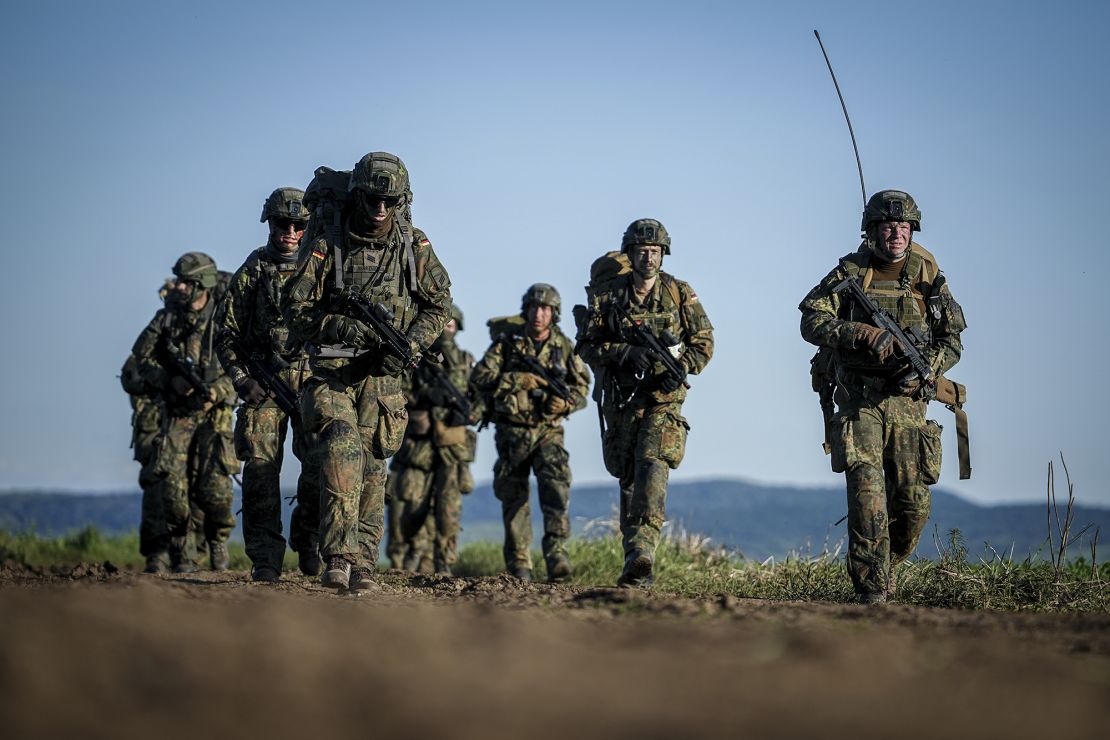 German paratroopers take up position after landing during a large NATO airborne exercise last May.