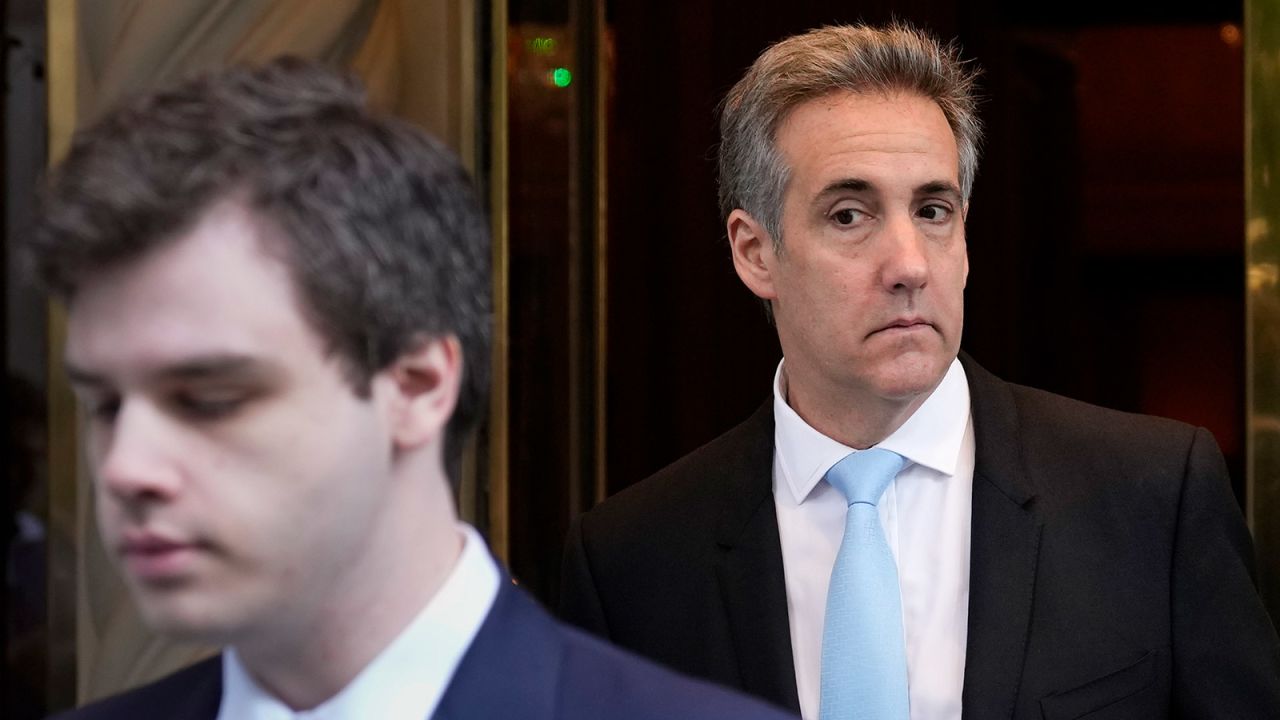 Michael Cohen, right, leaves his apartment building in New York on Tuesday, May 14, 2024.